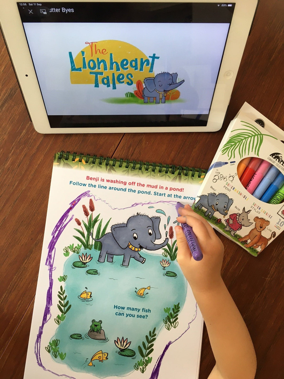 A child colouring a Lionheart activity page with superwashable pens